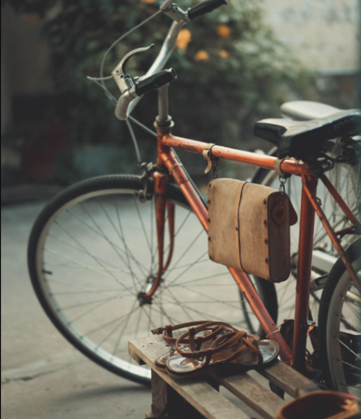 red bicycle with leather saddlebag