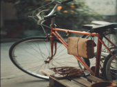 red bicycle with leather saddlebag