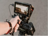 man holding a professional grade piece of filming equipment