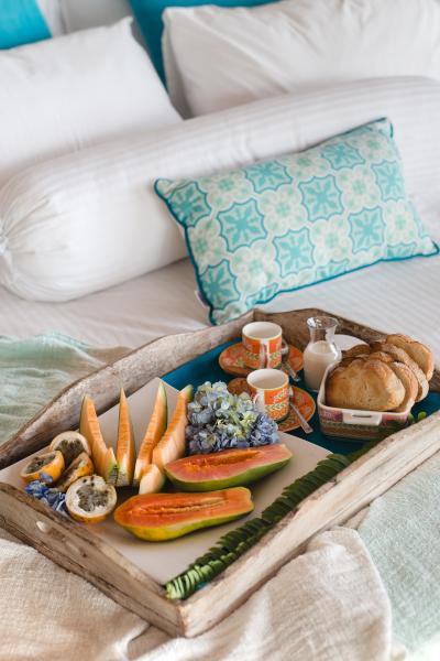 picture of a bed with a tray containing breakfast food on top